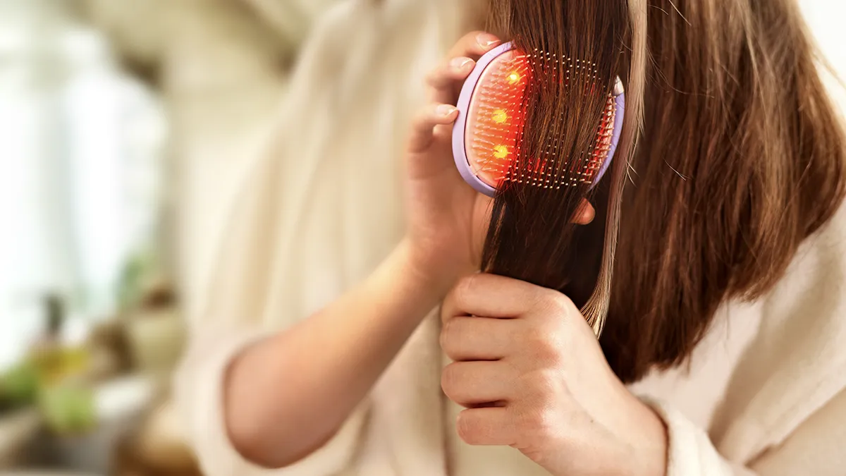 a woman brushing her hair with FLIP play brush